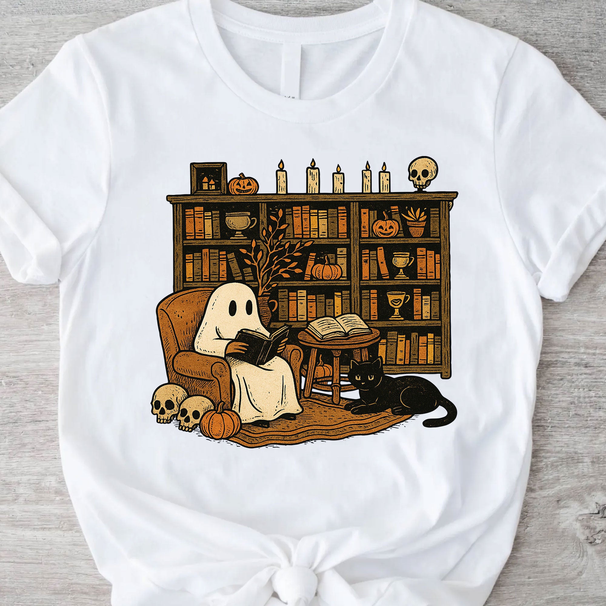Cozy Halloween Ghost T-Shirt with Bookshelf, Cat, and Pumpkin – Perfect Spooky Fall Outfit for Book Lovers and Autumn Enthusiasts
 - 11