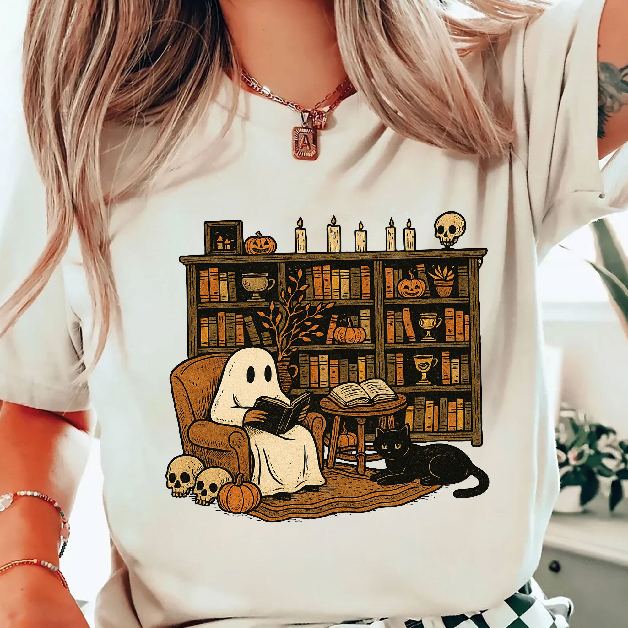 Cozy Halloween Ghost T-Shirt with Bookshelf, Cat, and Pumpkin – Perfect Spooky Fall Outfit for Book Lovers and Autumn Enthusiasts
 - 2