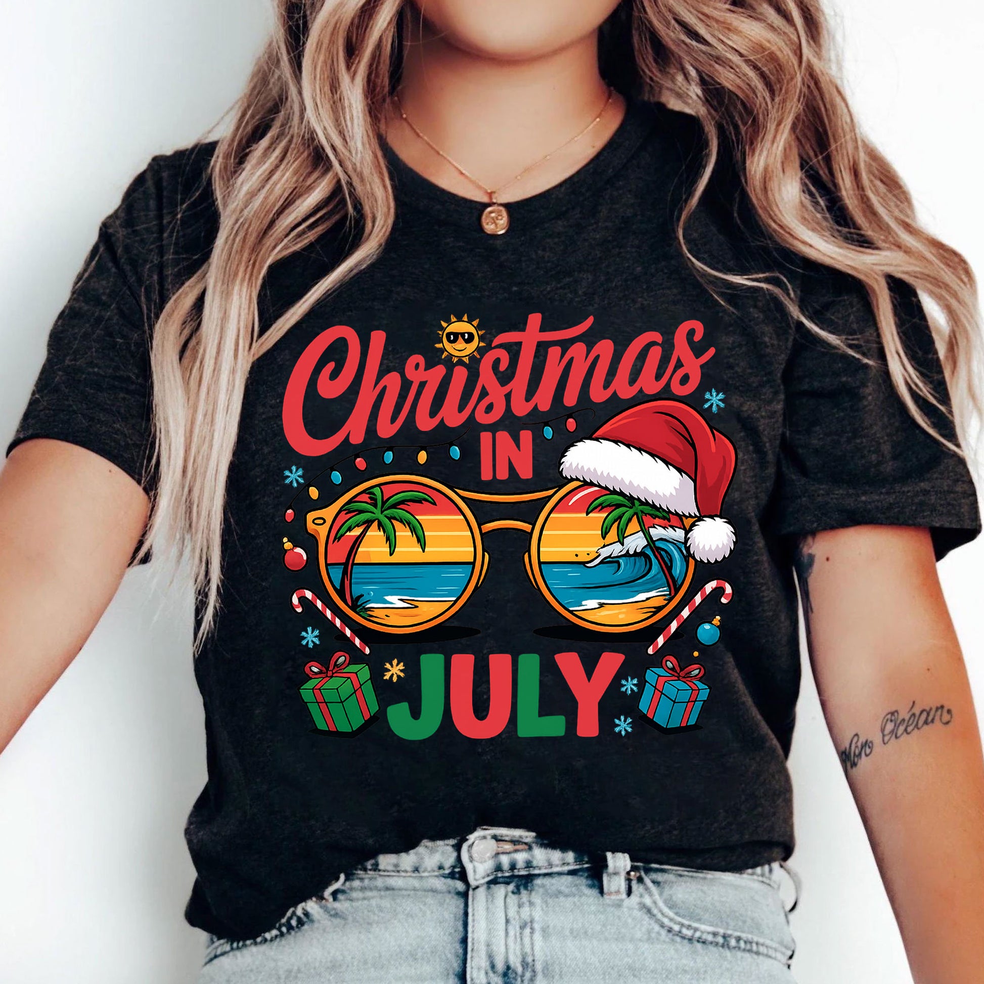Festive Christmas in July Women's T-Shirt: Fun Holiday Graphic Tee Featuring Beach Scene, Sunglasses, and Santa Hat Design
 - 5
