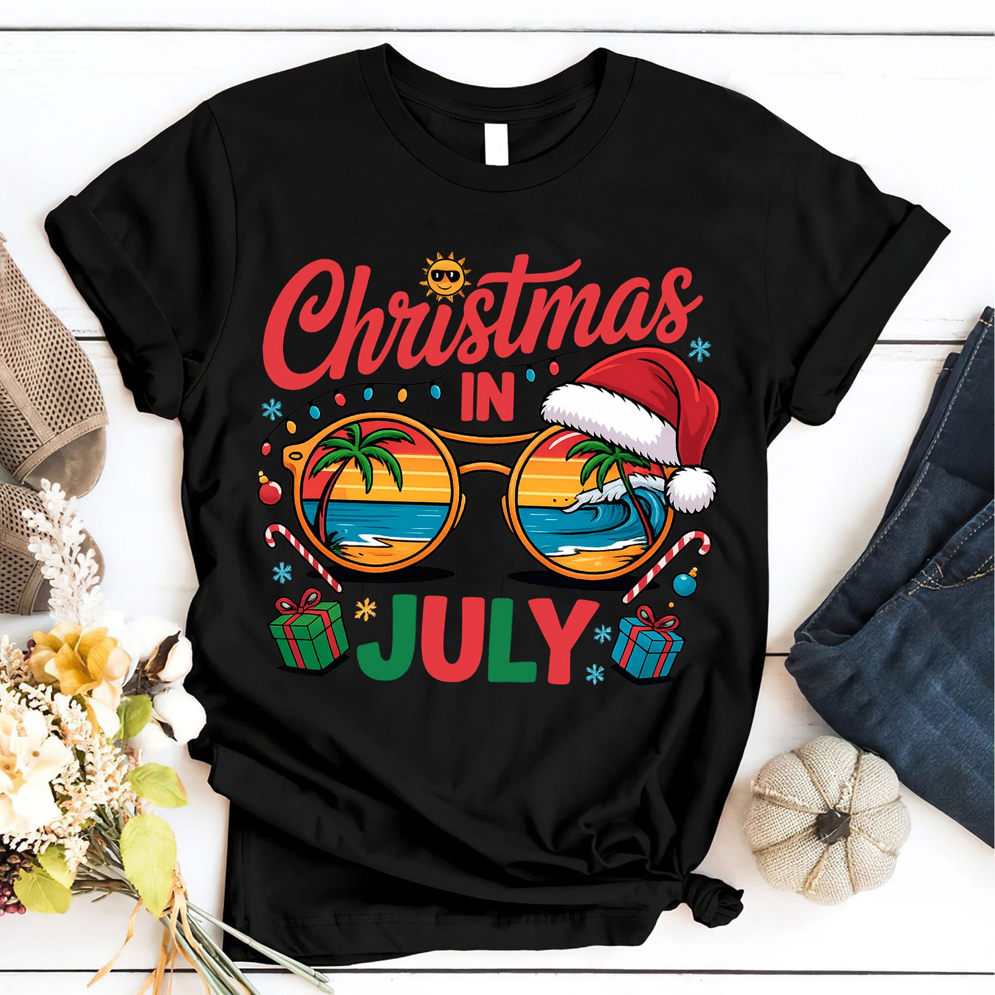 Festive Christmas in July Women's T-Shirt: Fun Holiday Graphic Tee Featuring Beach Scene, Sunglasses, and Santa Hat Design
 - 6